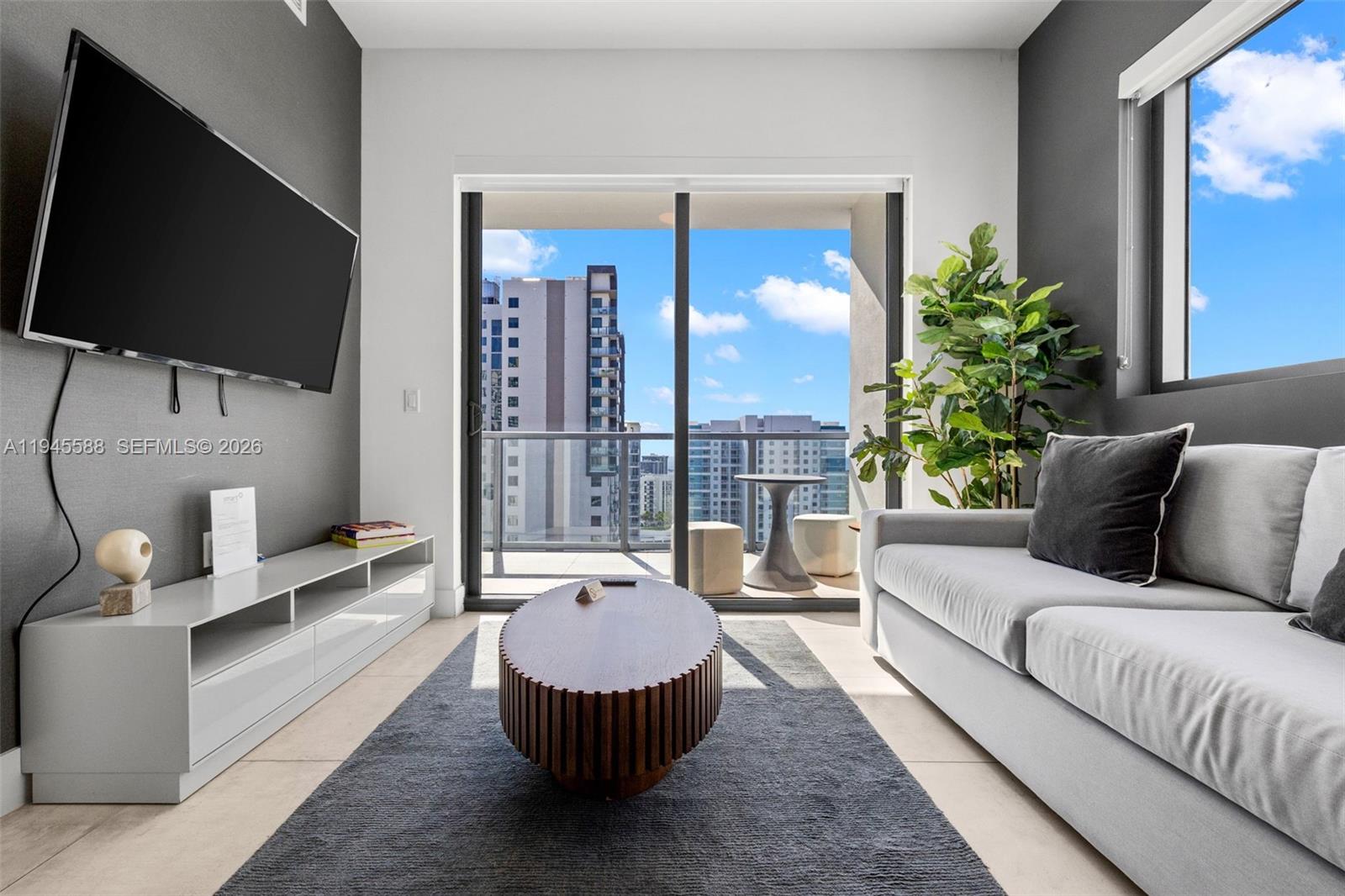 239 Southwest 9th Street, Unit 2102 Miami, FL 33130 - Photo 15 of 35 a living room with furniture and a flat screen tv