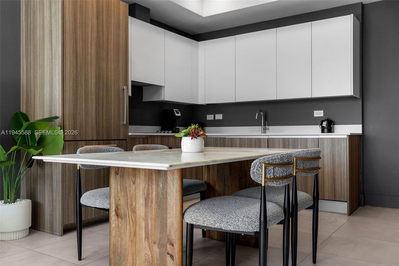 239 Southwest 9th Street, Unit 2102 Miami, FL 33130 - Photo 17 of 35 a kitchen with a table chairs sink and cabinets