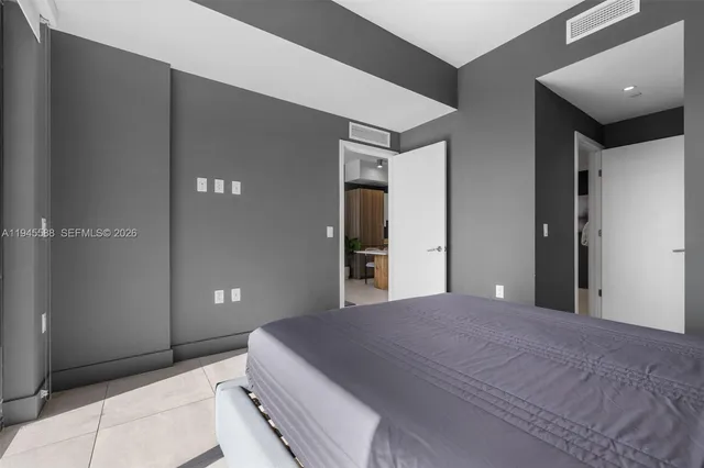 a bedroom with a bed and a potted plant