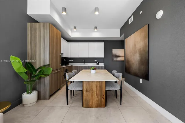 a kitchen with counter top space cabinets and a potted plant