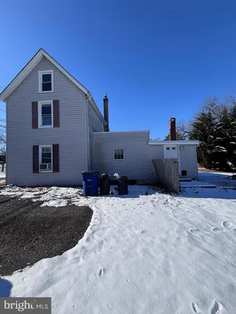 a front view of a house with cars parked