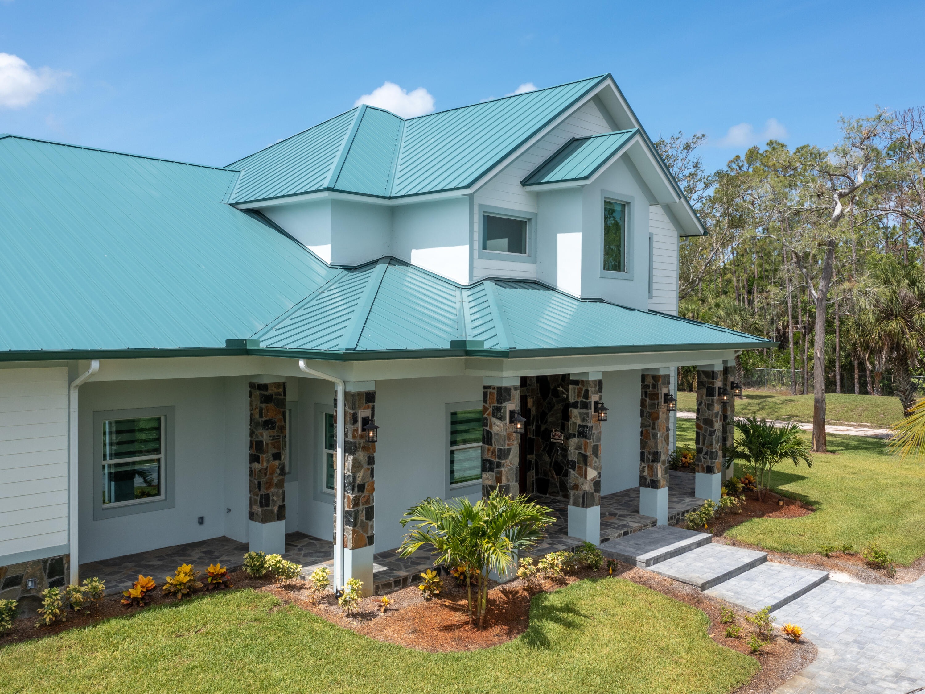 256 Price Street Naples, FL 34113 - Photo 16 of 42 a front view of a house with garden