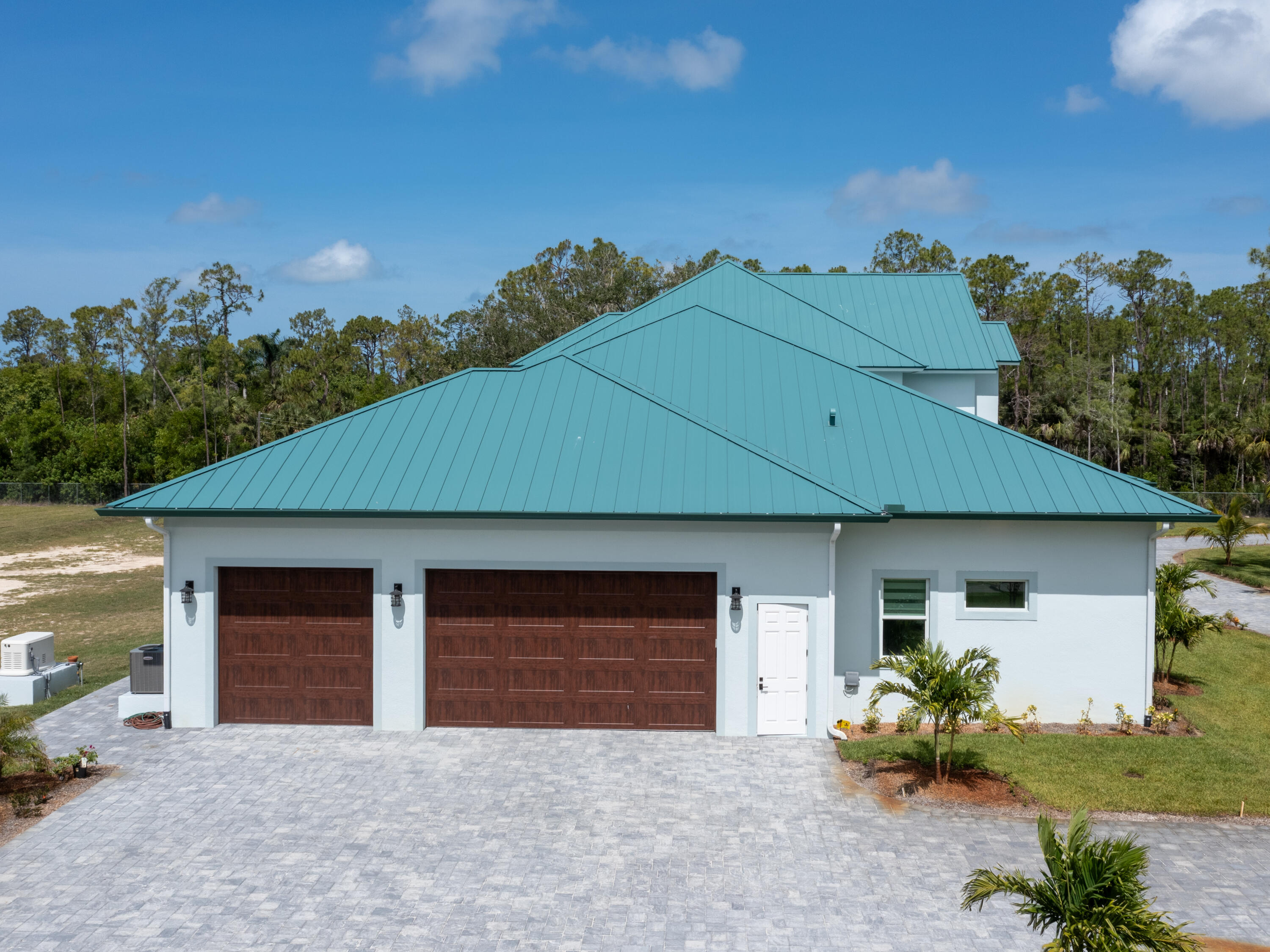 256 Price Street Naples, FL 34113 - Photo 17 of 42 a front view of a house with a yard and garage