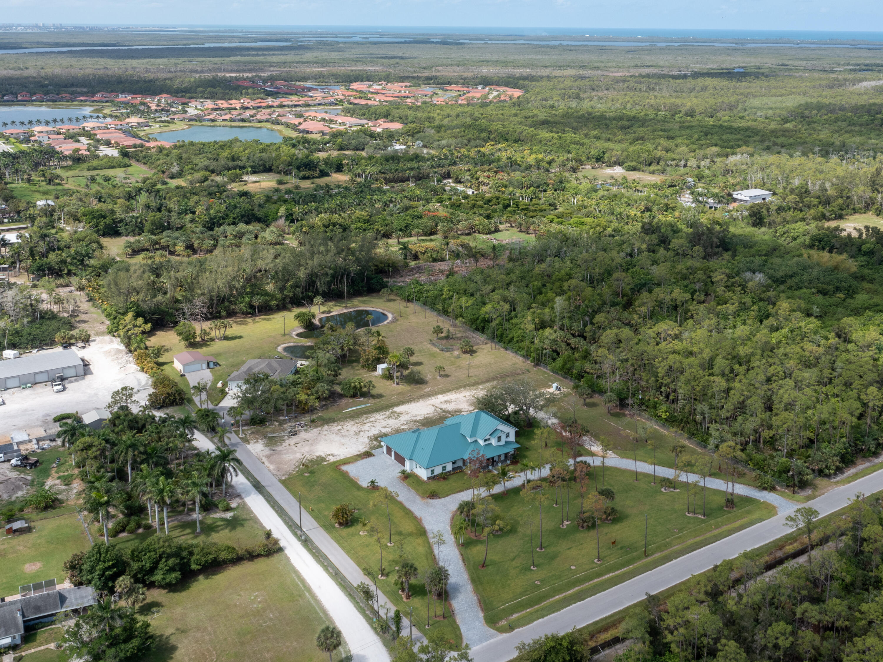 256 Price Street Naples, FL 34113 - Photo 2 of 42 view of a forest with a yard