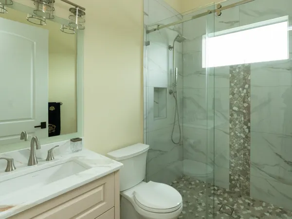 a bathroom with a double vanity sink and a mirror