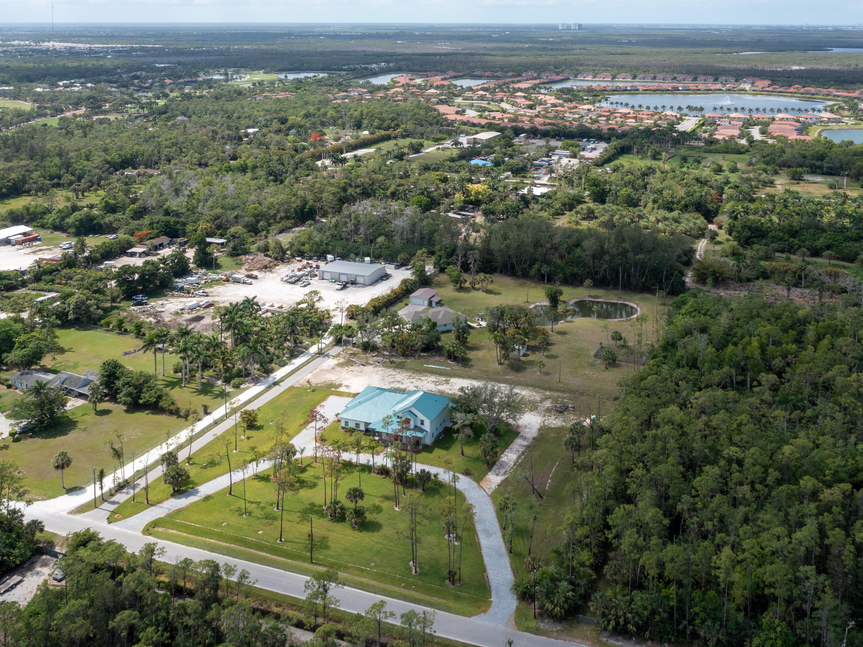 256 Price Street Naples, FL 34113 - Photo 3 of 42 an aerial view of residential houses with outdoor space and trees