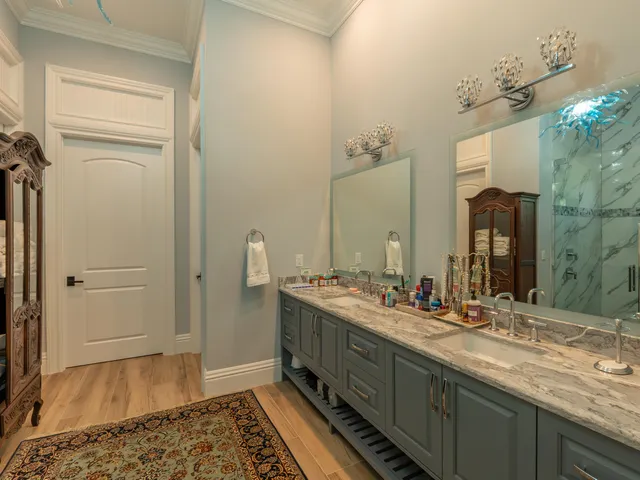 a bathroom with a granite countertop toilet a sink and mirror