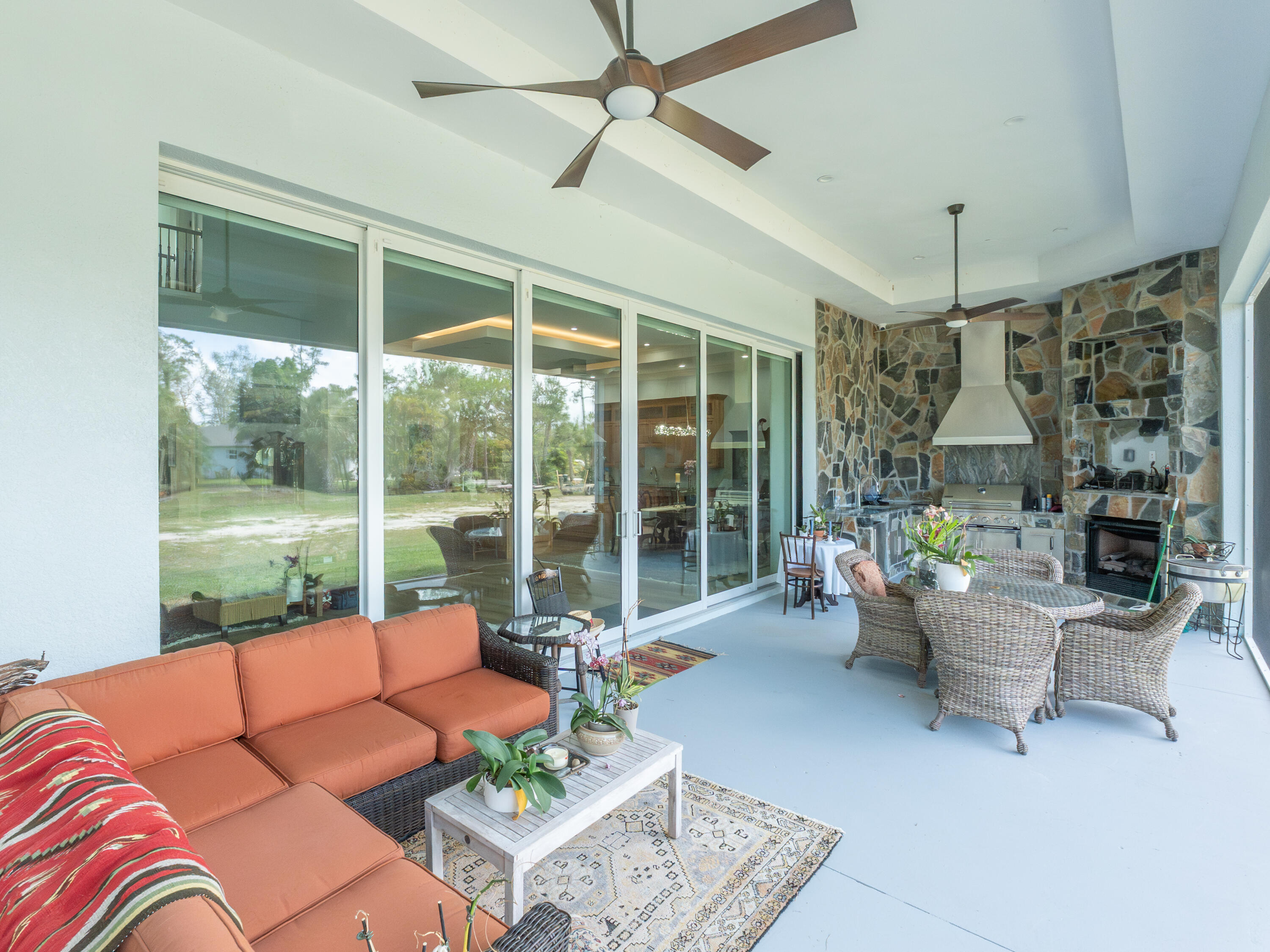 256 Price Street Naples, FL 34113 - Photo 35 of 42 a living room with furniture and a floor to ceiling window