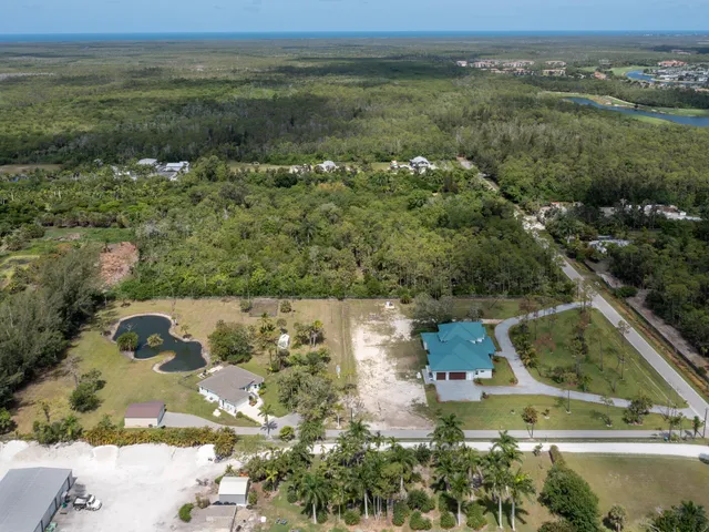 an aerial view of residential houses with outdoor space and swimming pool