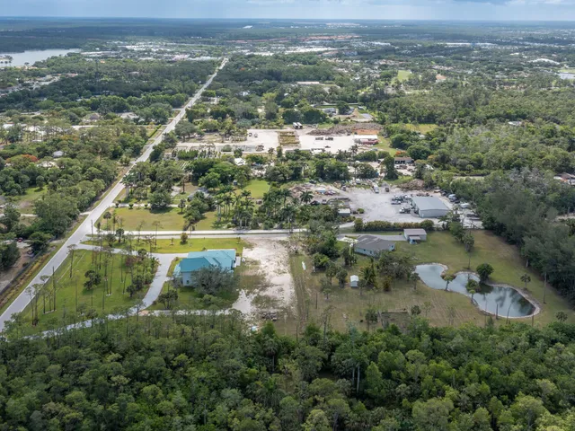 an aerial view of a house with outdoor space and swimming pool