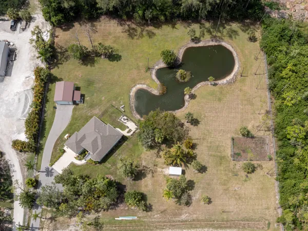 an aerial view of a residential houses with outdoor space