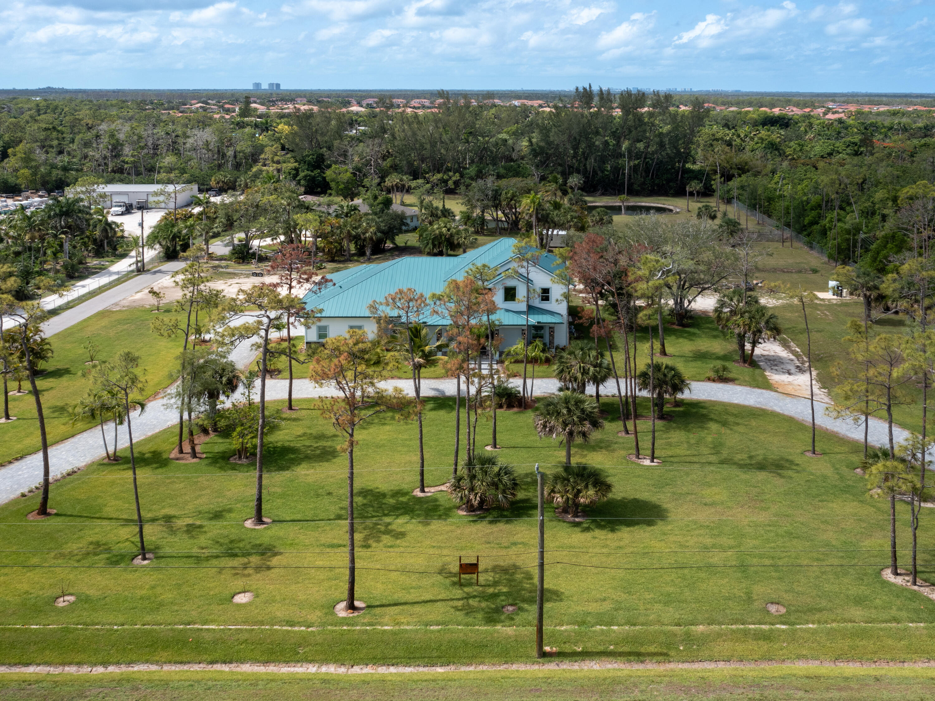 256 Price Street Naples, FL 34113 - Photo 10 of 42 a view of a house with a swimming pool