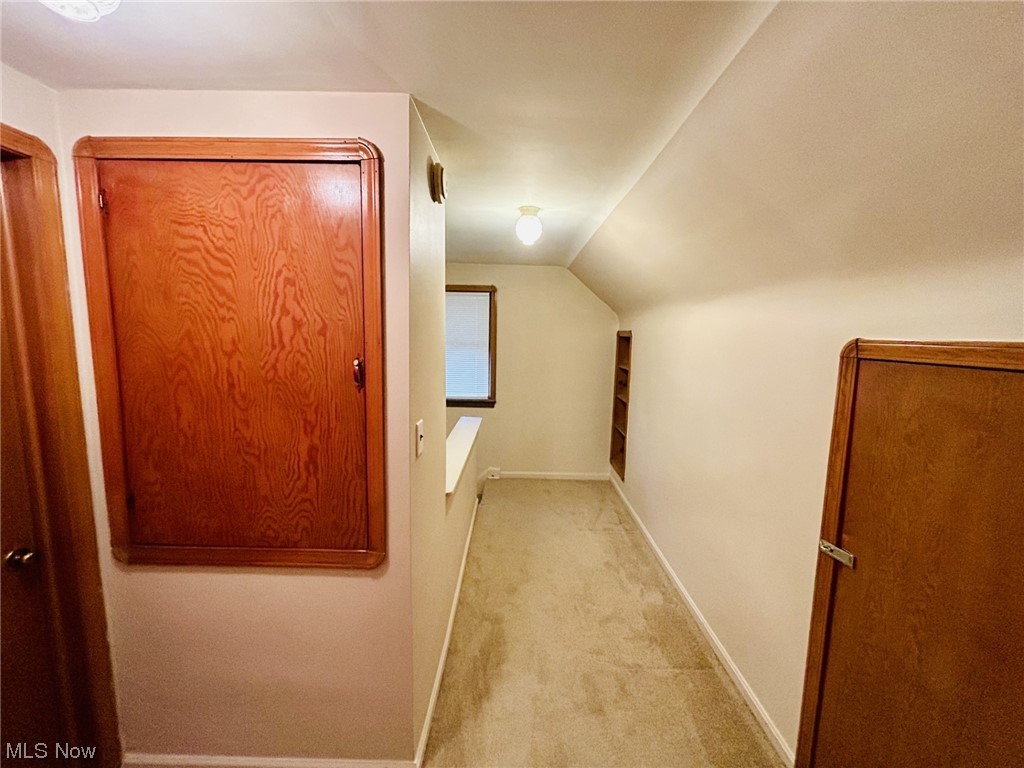 13414 Rockside Road Garfield Heights, OH 44125 - Photo 15 of 25 Corridor with lofted ceiling and light carpet