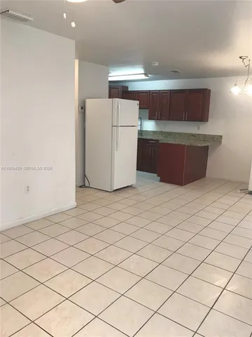 a kitchen with stainless steel appliances a refrigerator and a stove top oven