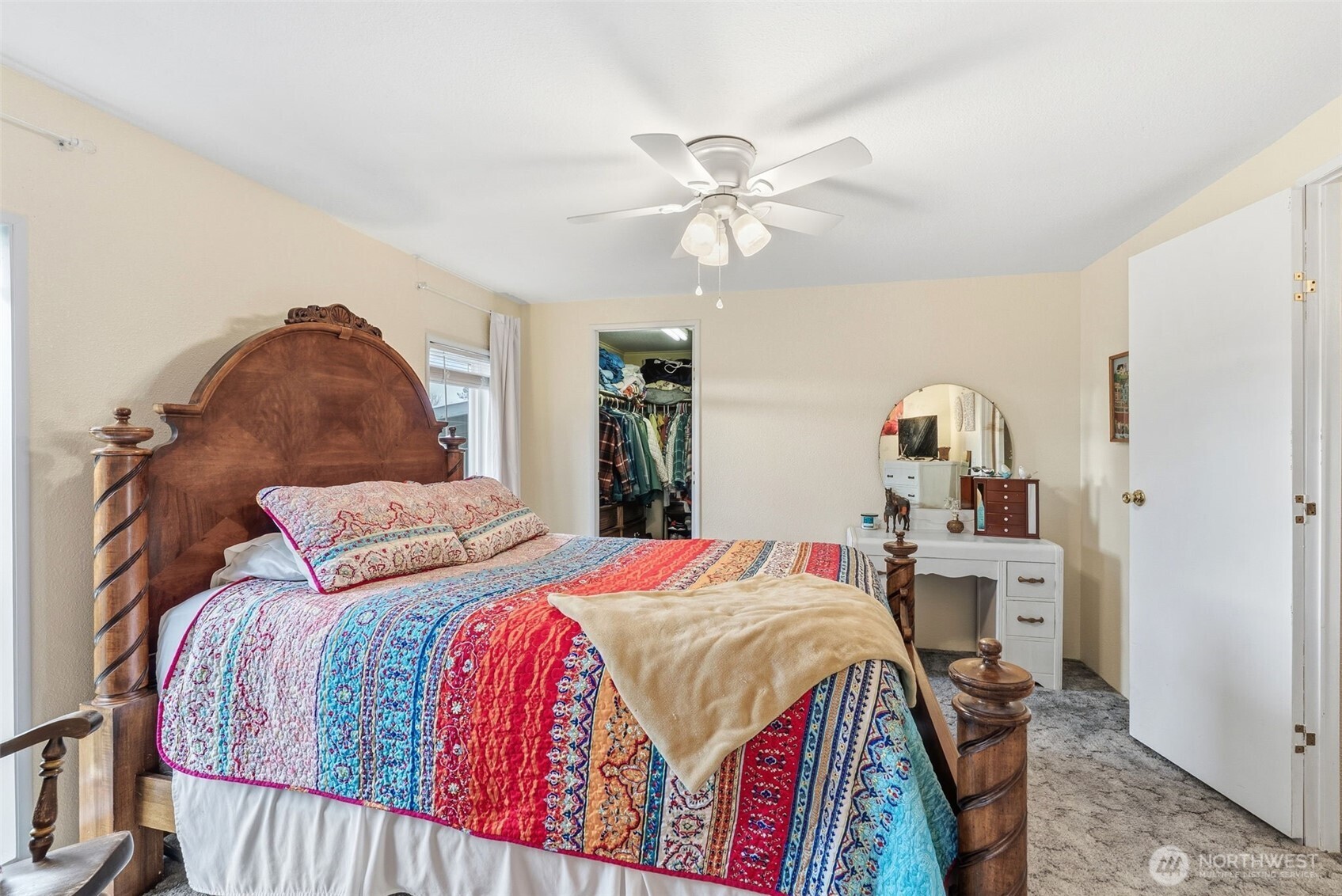 129 Arlington Place Longview, WA 98632 - Photo 17 of 27 a bedroom with a bed and a chandelier