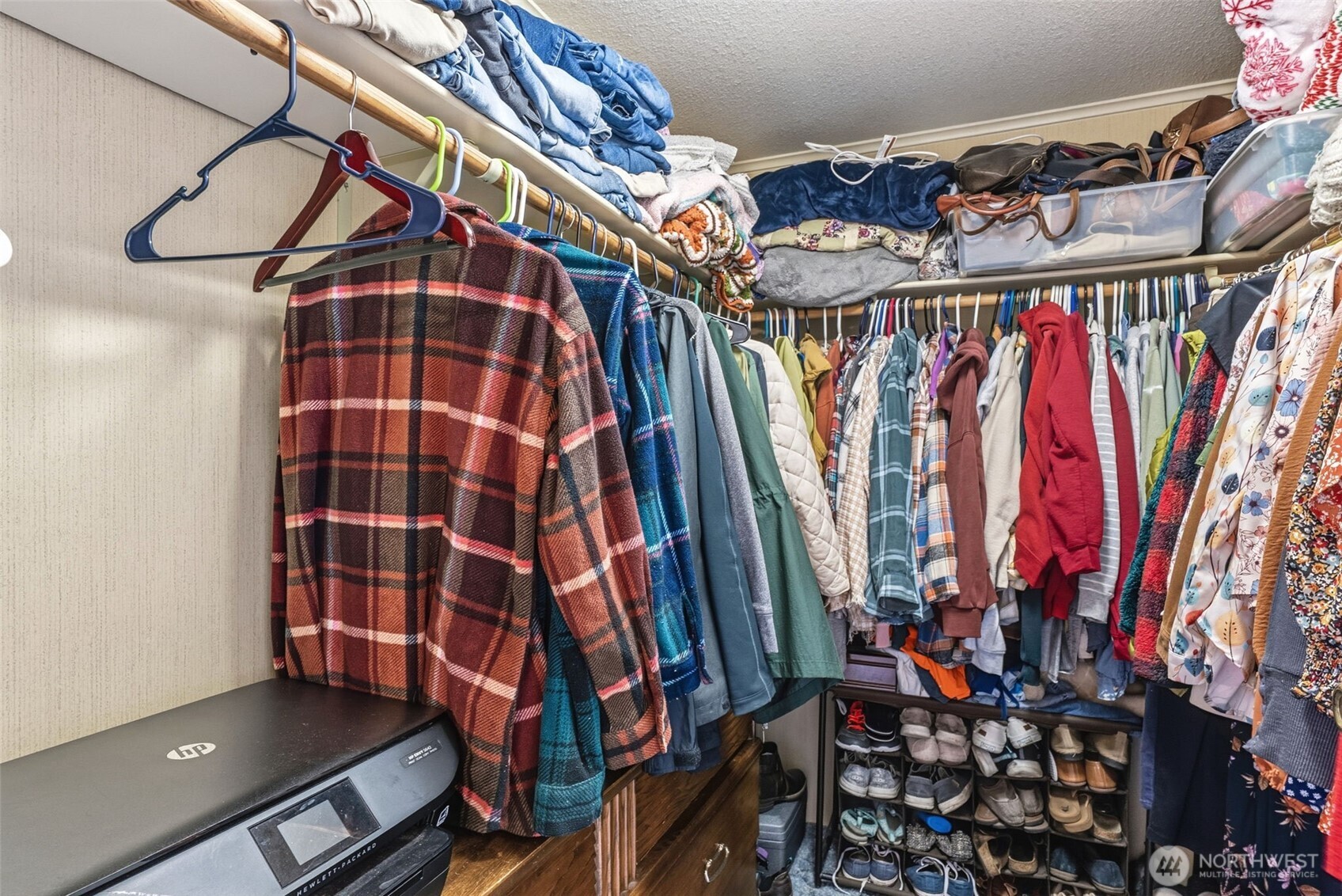 129 Arlington Place Longview, WA 98632 - Photo 18 of 27 a view of walk in closet with clothes and shoes