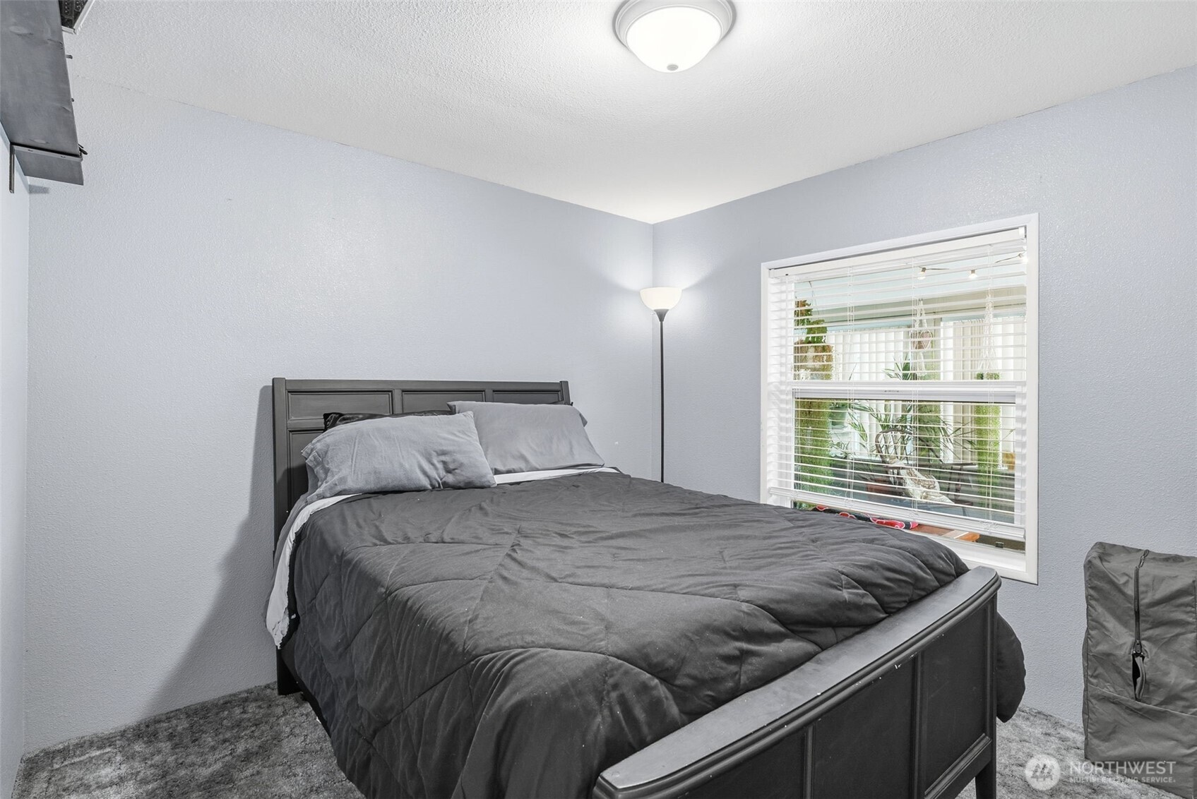 129 Arlington Place Longview, WA 98632 - Photo 19 of 27 a bedroom with a bed and wooden floor