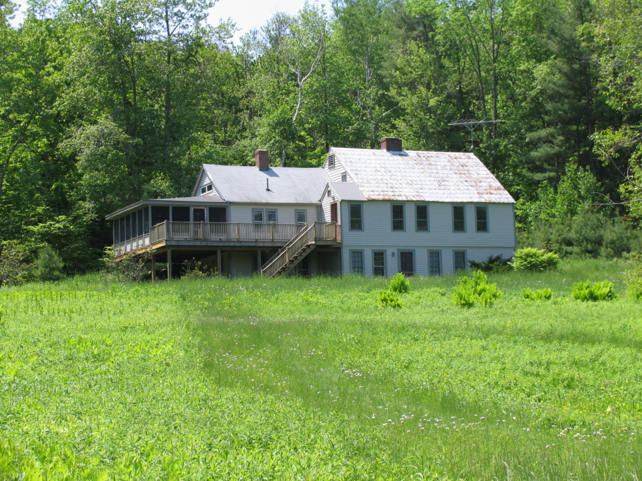 a aerial view of a house with a garden and deck
