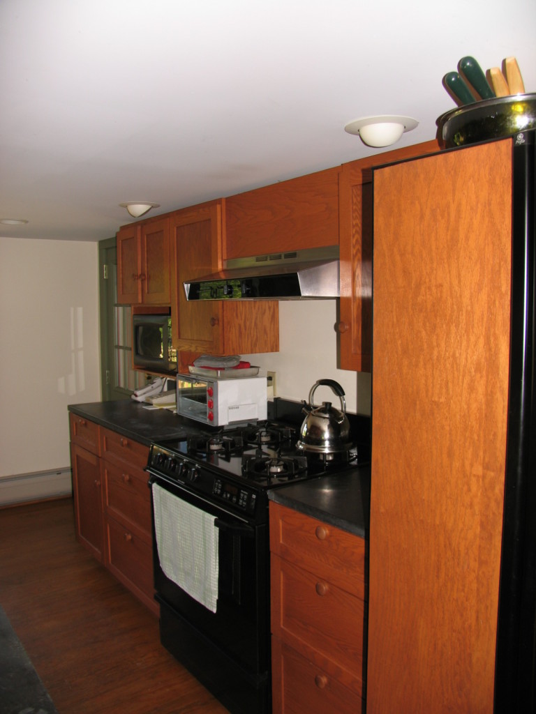 470 Ed Jones Road Otis, MA 01253 - Photo 15 of 24 a kitchen with stainless steel appliances a stove a microwave and wooden cabinets