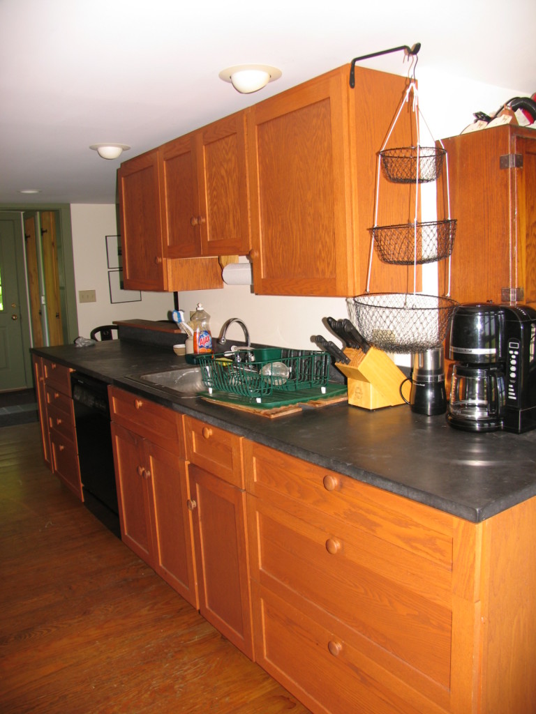 470 Ed Jones Road Otis, MA 01253 - Photo 6 of 24 a kitchen with stainless steel appliances granite countertop a sink a stove and a microwave