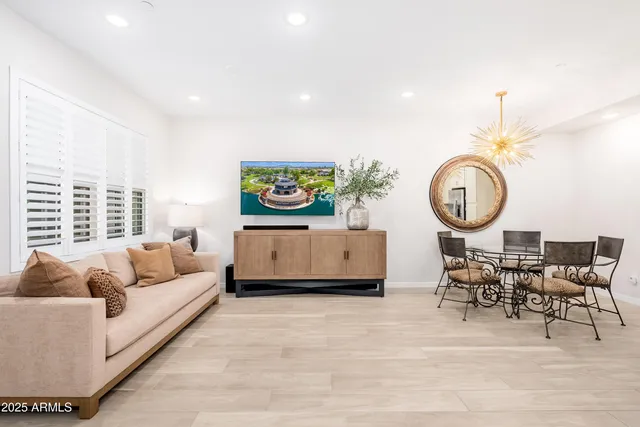 a kitchen with a dining table chairs and a refrigerator