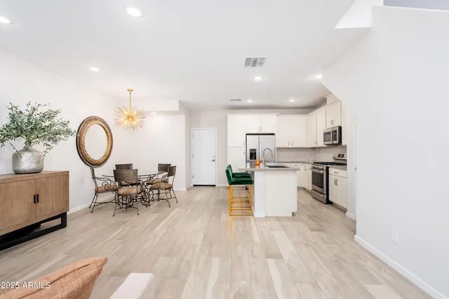 a view of a dining room with furniture and a chandelier