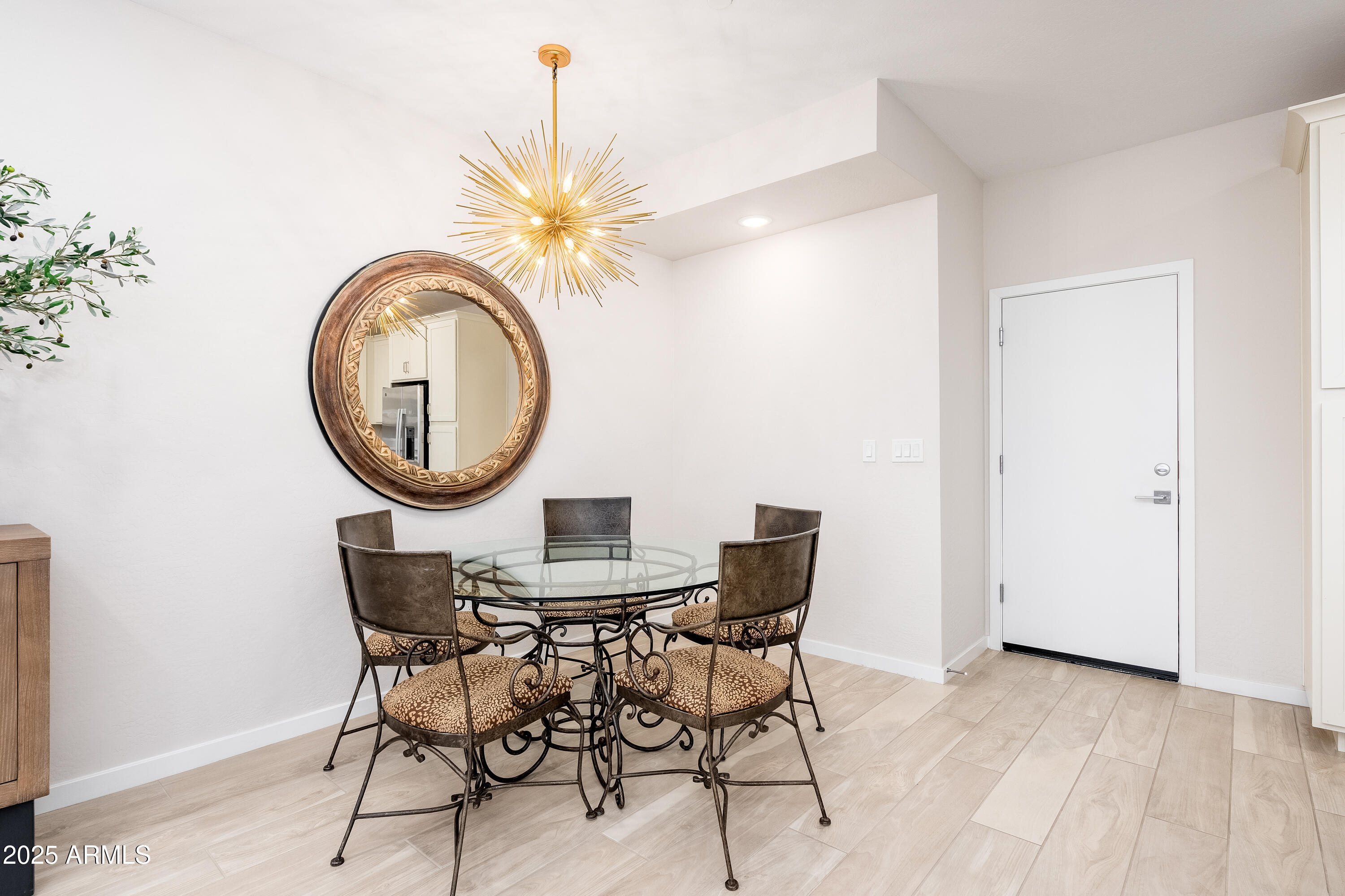724 East Lark Street, Unit 102 Gilbert, AZ 85297 - Photo 15 of 54 a view of a dining room with furniture and a chandelier