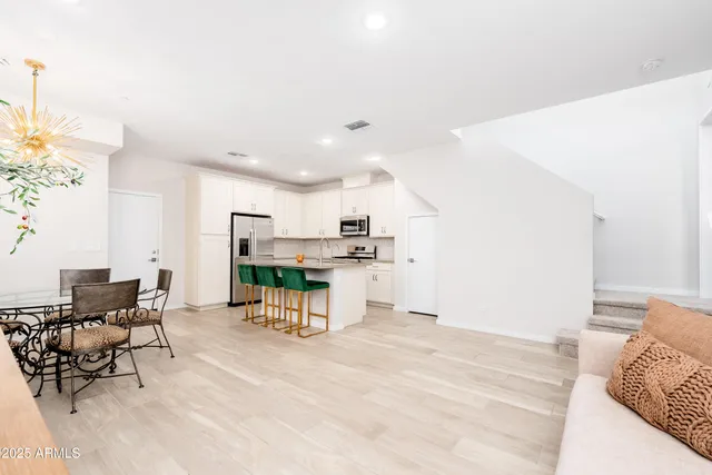 a kitchen with stainless steel appliances kitchen island granite countertop a refrigerator and a stove top oven