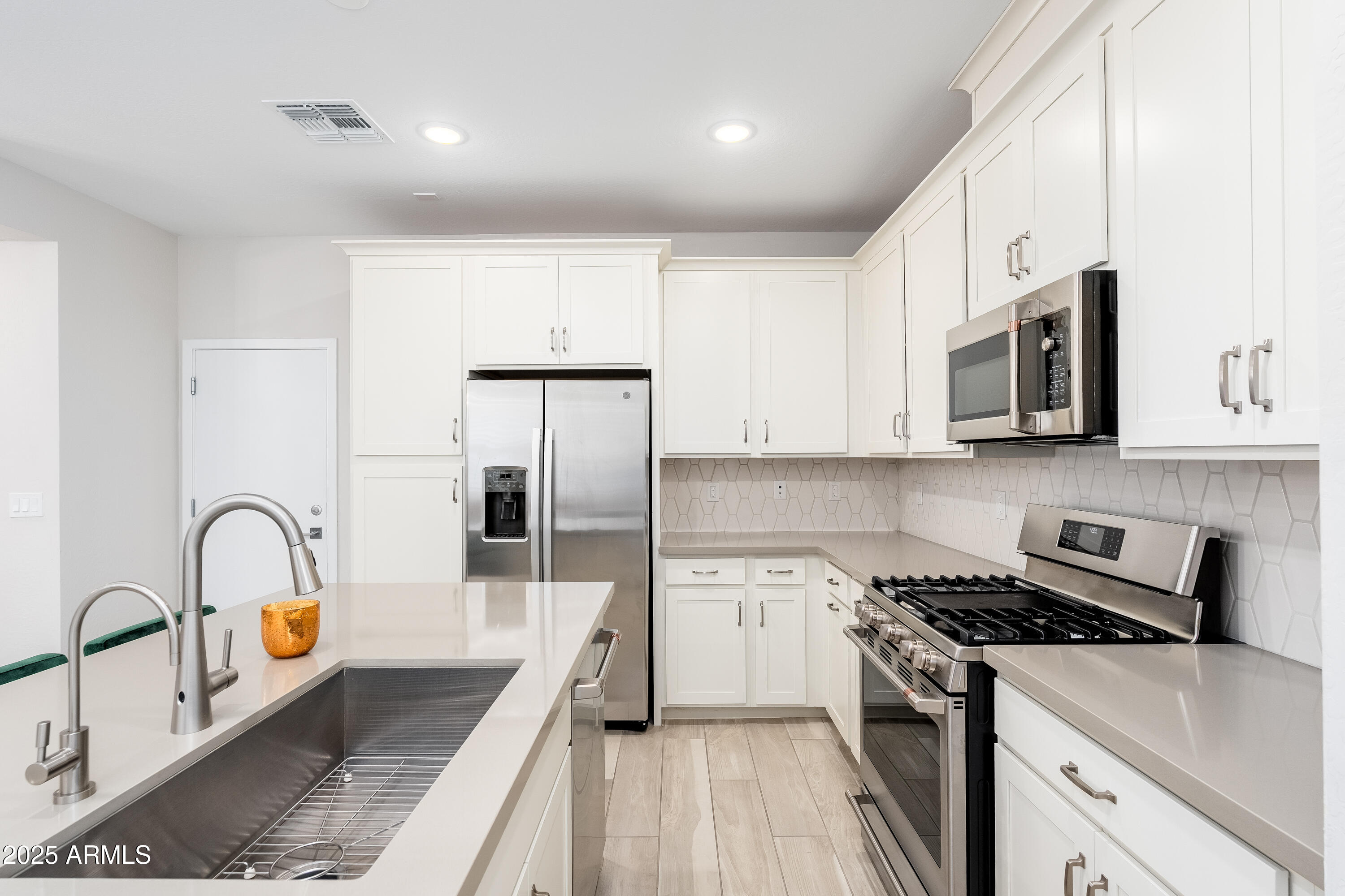 724 East Lark Street, Unit 102 Gilbert, AZ 85297 - Photo 18 of 54 a kitchen with stainless steel appliances granite countertop a stove a sink and a microwave