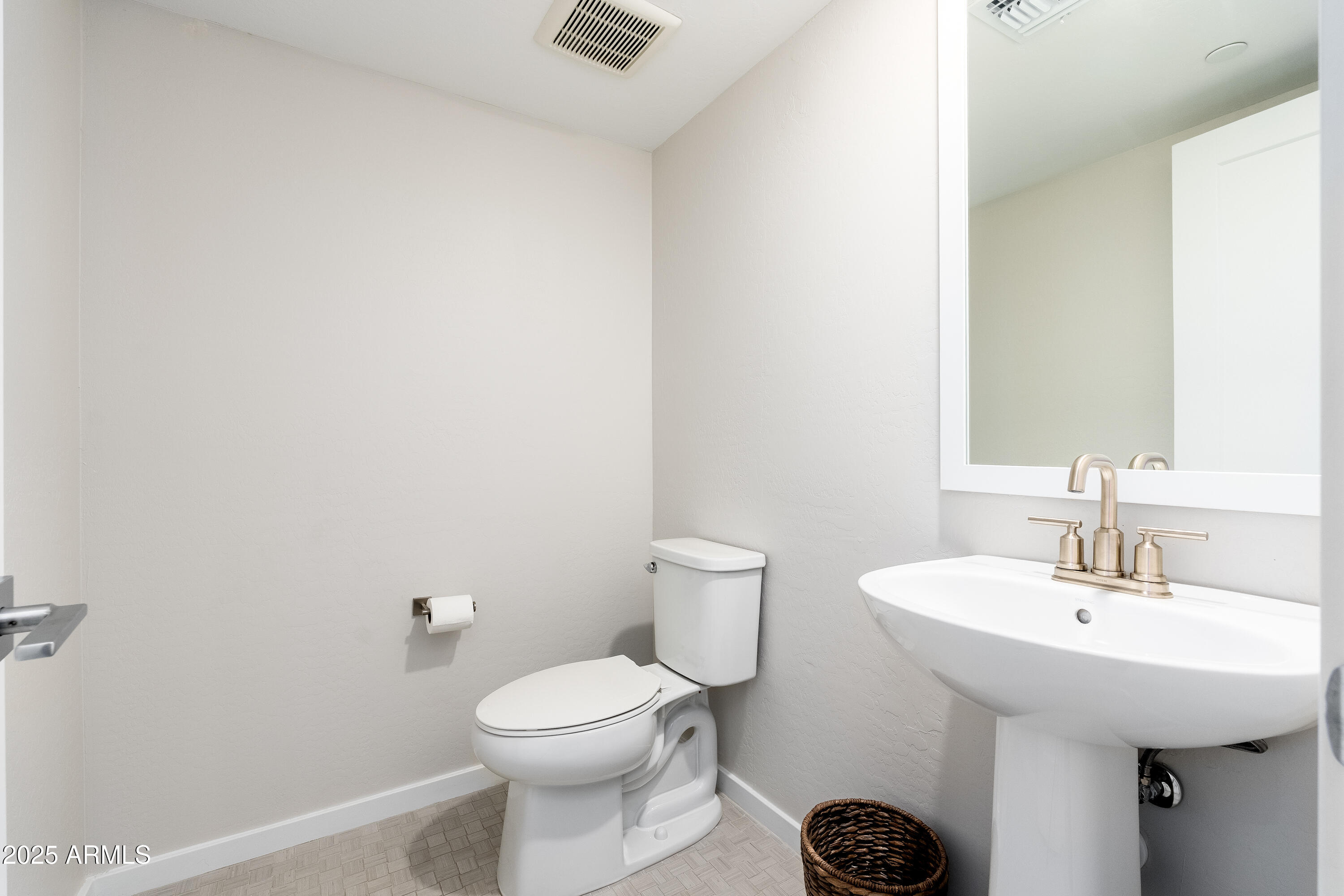 724 East Lark Street, Unit 102 Gilbert, AZ 85297 - Photo 27 of 54 a bathroom with a sink a toilet and mirror