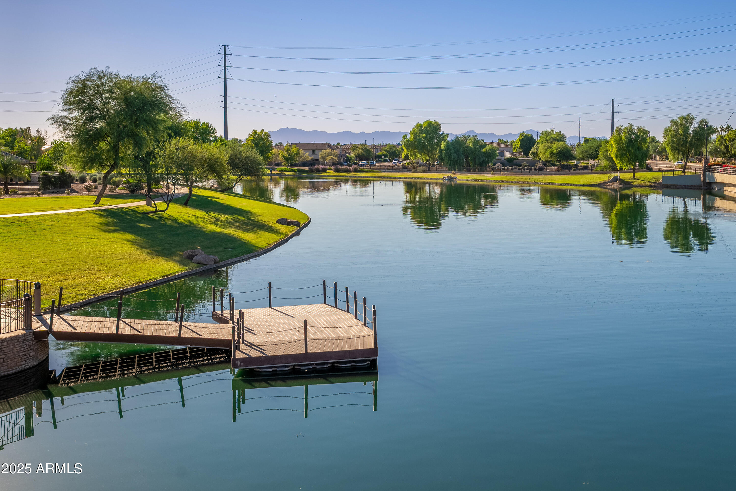 724 East Lark Street, Unit 102 Gilbert, AZ 85297 - Photo 45 of 54 a view of a lake with couches chairs and wooden floor