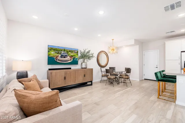 a living room with furniture a rug and a window