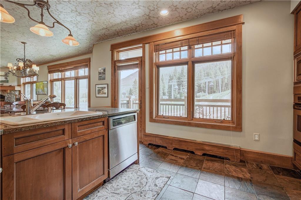 280 Trailhead Drive, Unit 3016 Keystone, CO 80435 - Photo 13 of 35 a kitchen with stainless steel appliances granite countertop a sink and a stove next to a window
