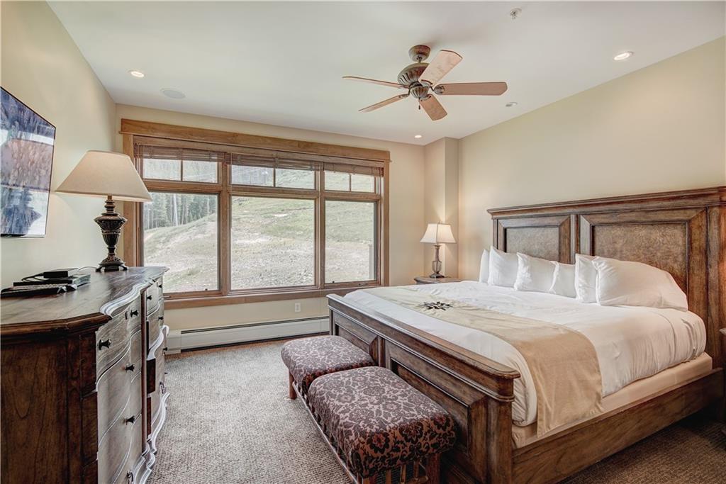280 Trailhead Drive, Unit 3016 Keystone, CO 80435 - Photo 15 of 35 a bedroom with a large bed and a chandelier