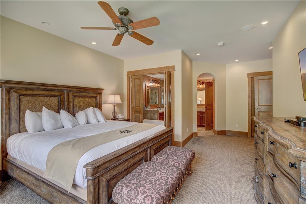 280 Trailhead Drive, Unit 3016 Keystone, CO 80435 - Photo 16 of 35 a bedroom with a bed and a chandelier