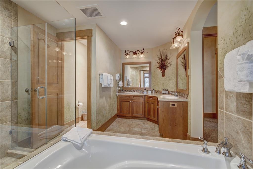 280 Trailhead Drive, Unit 3016 Keystone, CO 80435 - Photo 18 of 35 a bathroom with a tub sink shower and mirror