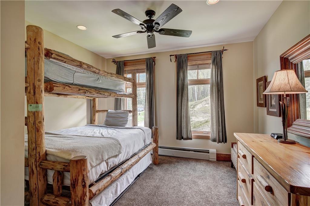 280 Trailhead Drive, Unit 3016 Keystone, CO 80435 - Photo 21 of 35 a bedroom with a bed and a chandelier