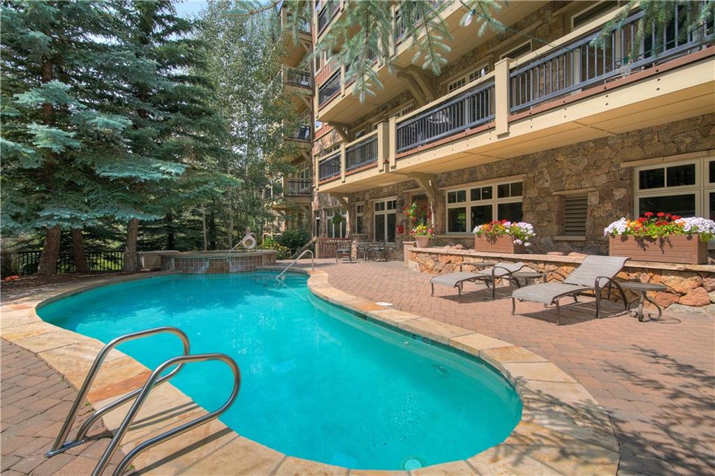 280 Trailhead Drive, Unit 3016 Keystone, CO 80435 - Photo 29 of 35 a view of a swimming pool with a lounge chairs in patio