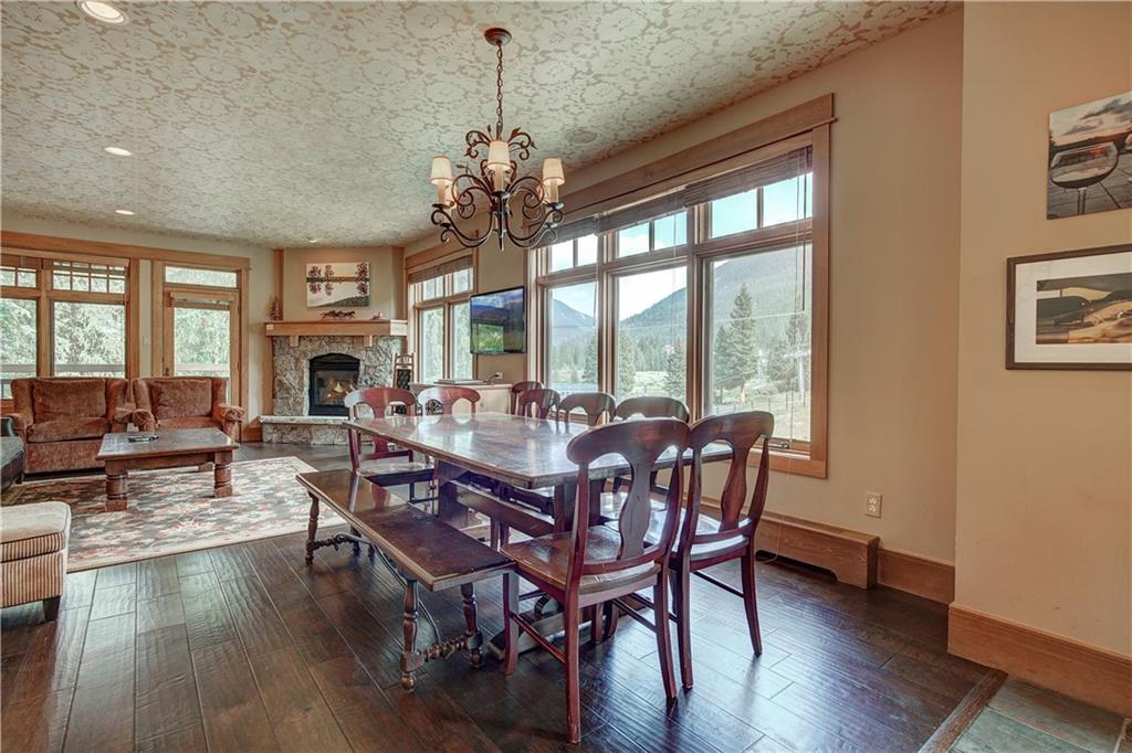 280 Trailhead Drive, Unit 3016 Keystone, CO 80435 - Photo 8 of 35 a view of a dining room with furniture window and wooden floor