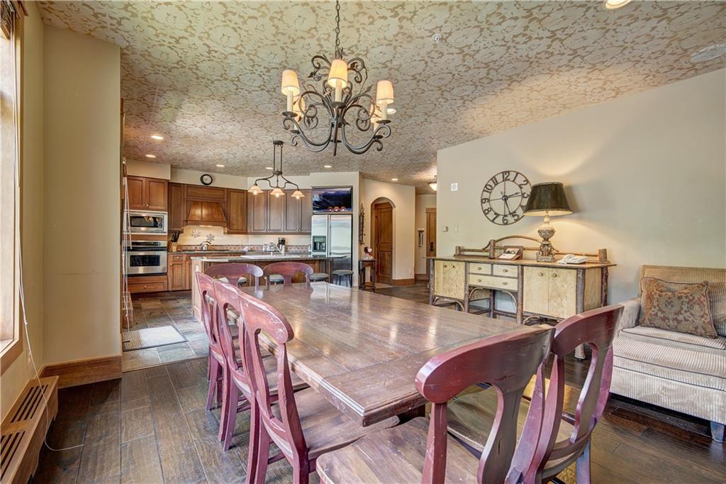 280 Trailhead Drive, Unit 3016 Keystone, CO 80435 - Photo 9 of 35 a view of a dining room with furniture wooden floor and chandelier