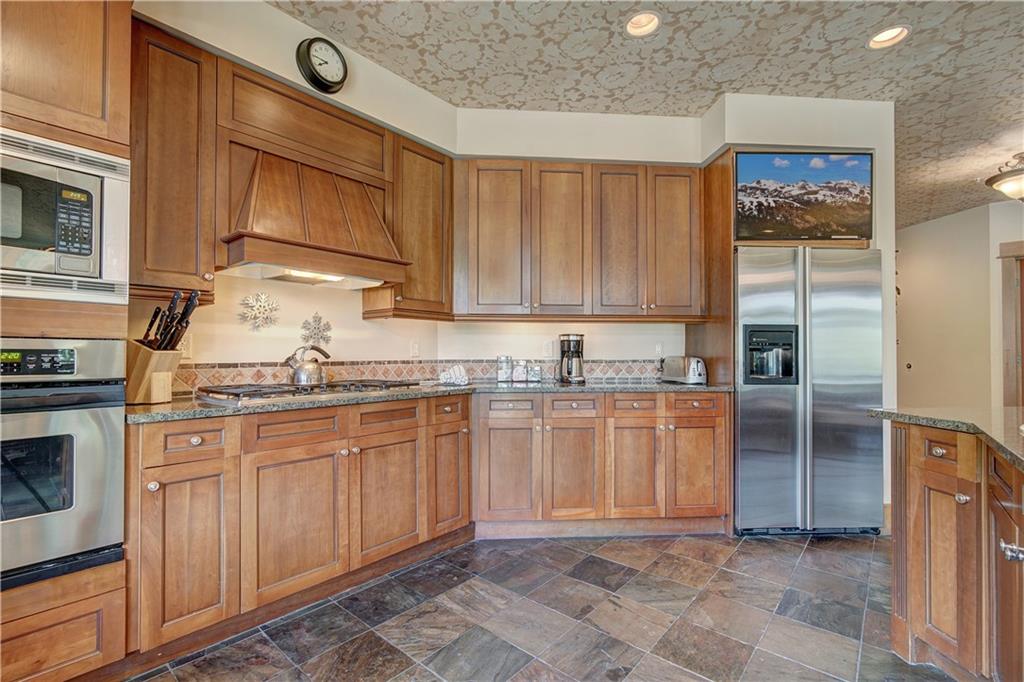 280 Trailhead Drive, Unit 3016 Keystone, CO 80435 - Photo 10 of 35 a kitchen with stainless steel appliances granite countertop a refrigerator and a stove top oven