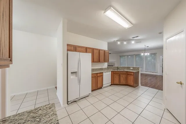 a kitchen with a refrigerator and a sink