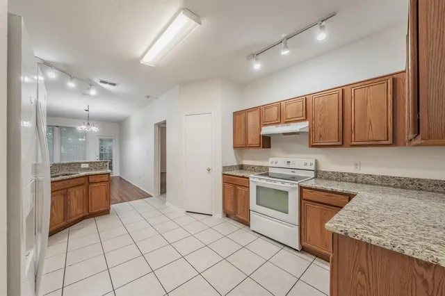 a kitchen with stainless steel appliances granite countertop a stove top oven a sink and dishwasher