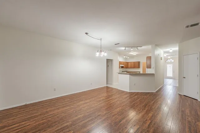 a view of a kitchen with a sink and wooden floor