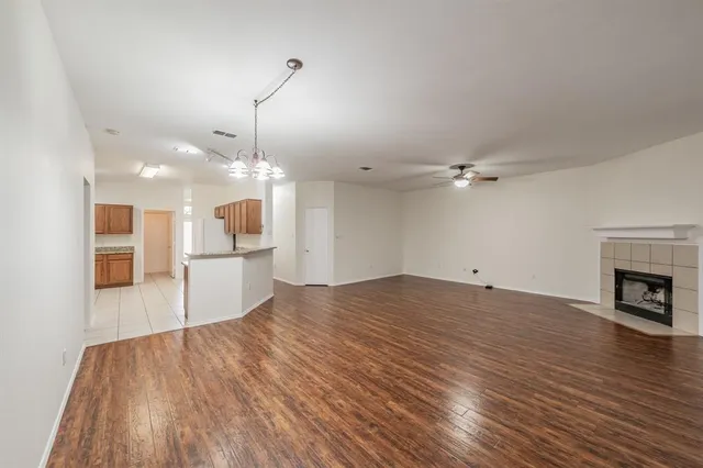 a view of a livingroom with wooden floor and a ceiling fan