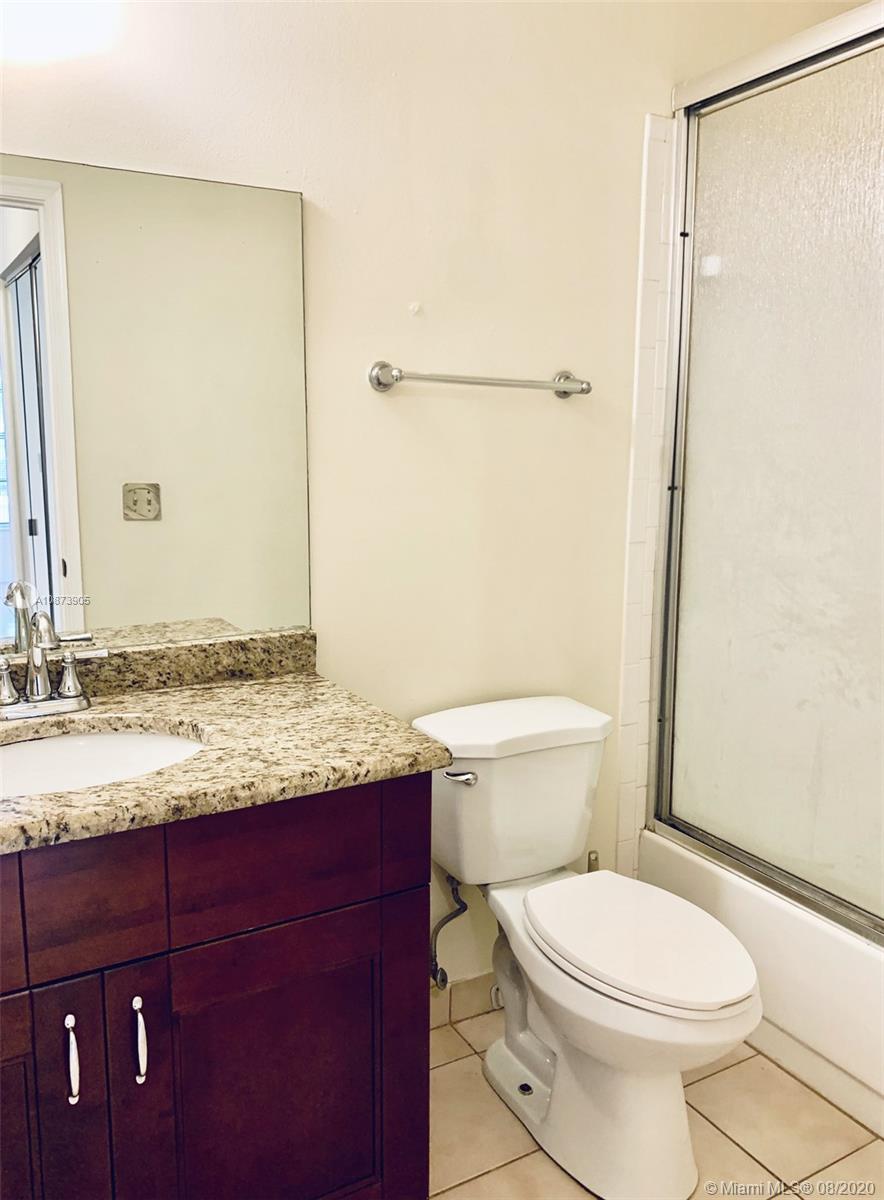 492 Hardwood Place, Unit 492 Boca Raton, FL 33431 - Photo 12 of 21 a bathroom with a granite countertop sink toilet and shower