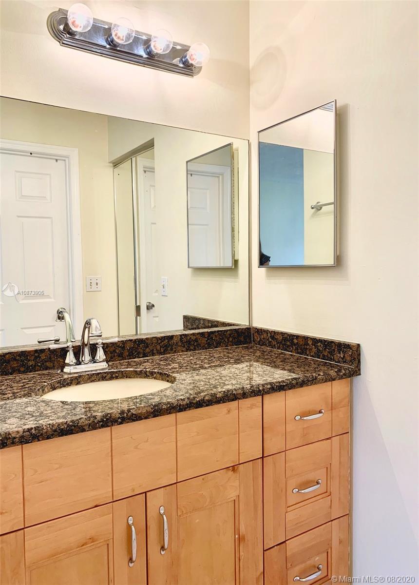 492 Hardwood Place, Unit 492 Boca Raton, FL 33431 - Photo 16 of 21 a bathroom with a granite countertop sink and a mirror