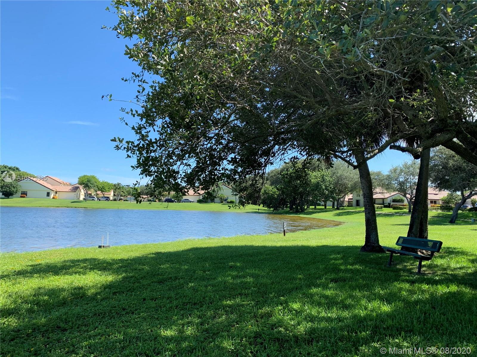 492 Hardwood Place, Unit 492 Boca Raton, FL 33431 - Photo 20 of 21 a view of an outdoor space and a yard