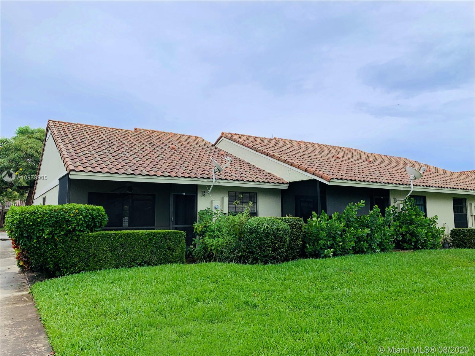 492 Hardwood Place, Unit 492 Boca Raton, FL 33431 - Photo 4 of 21 a front view of a house with a garden