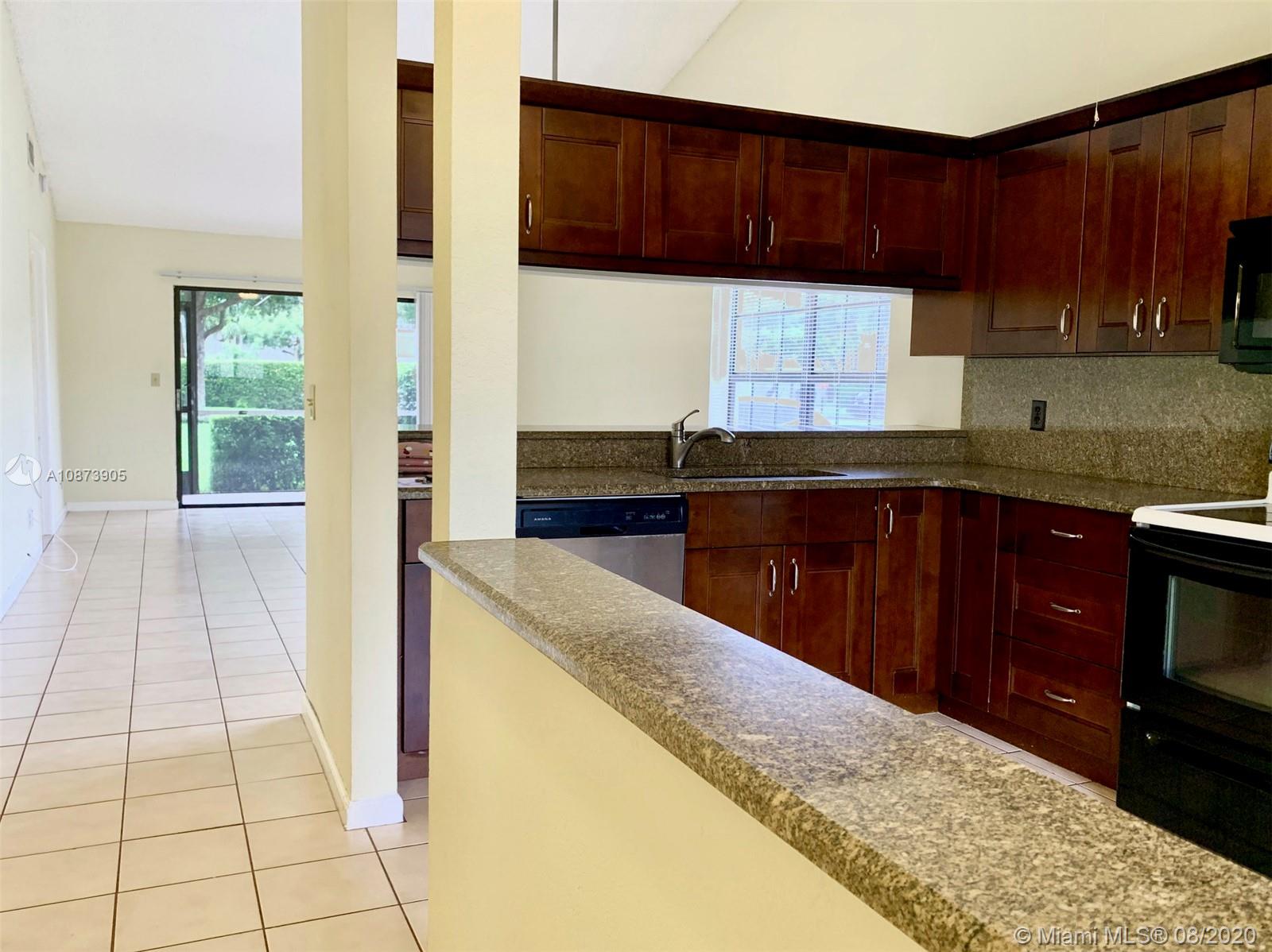 492 Hardwood Place, Unit 492 Boca Raton, FL 33431 - Photo 6 of 21 a kitchen with stainless steel appliances granite countertop a sink stove and cabinets